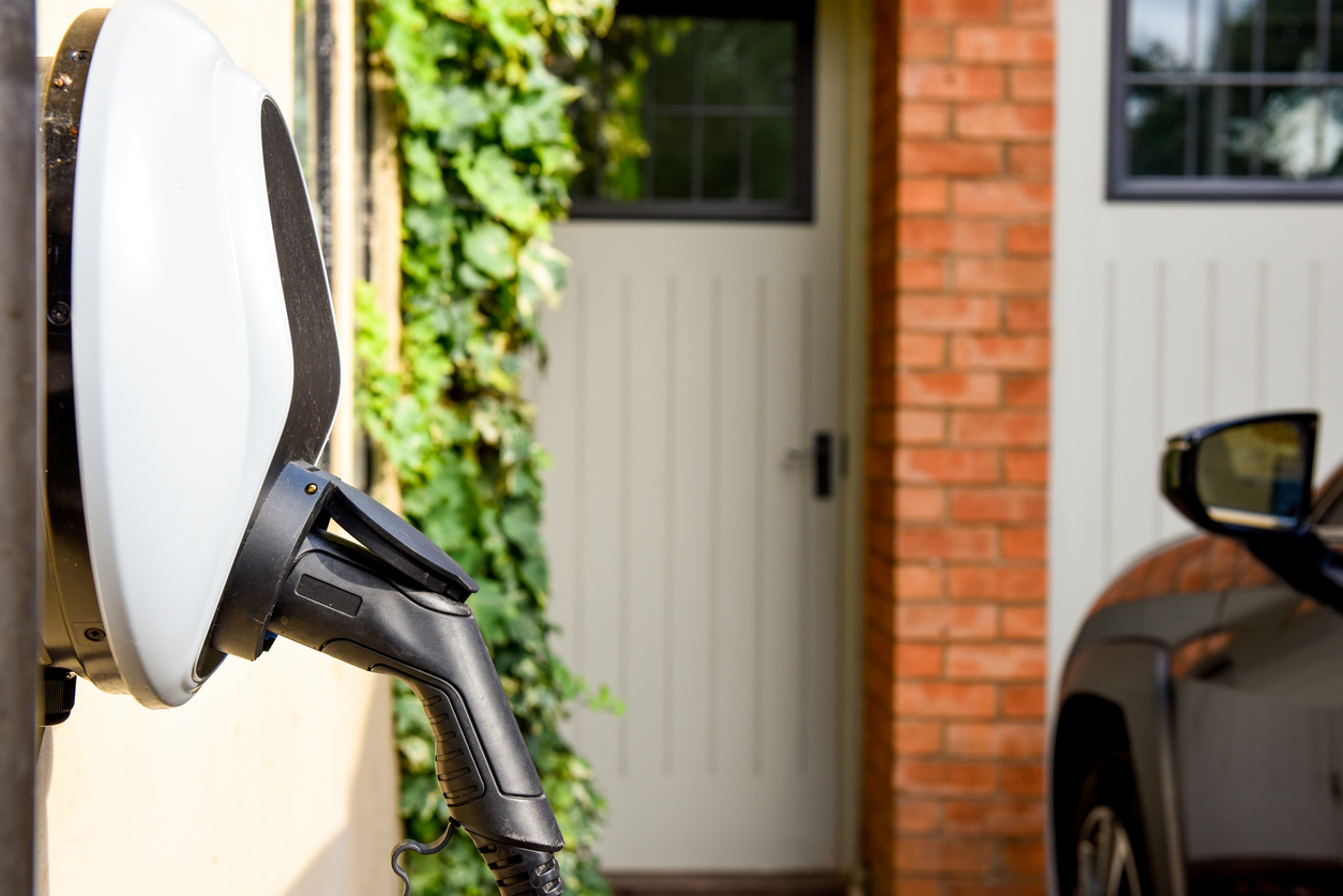 Wall mounted car charging unit to supply power to electric vehicles with copy space on house wall Wall mounted car charging unit to supply power to electric vehicles with copy space on house wall