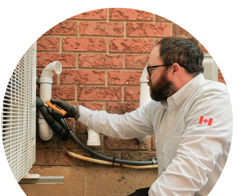 The Comfort Group HVAC specialist checking insulated piping on a heat pump unit beside a brick wall during a diagnostic service. The Comfort Group HVAC specialist checking insulated piping on a heat pump unit beside a brick wall during a diagnostic service.